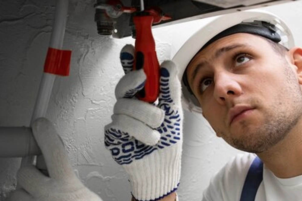 repair man repairing ac